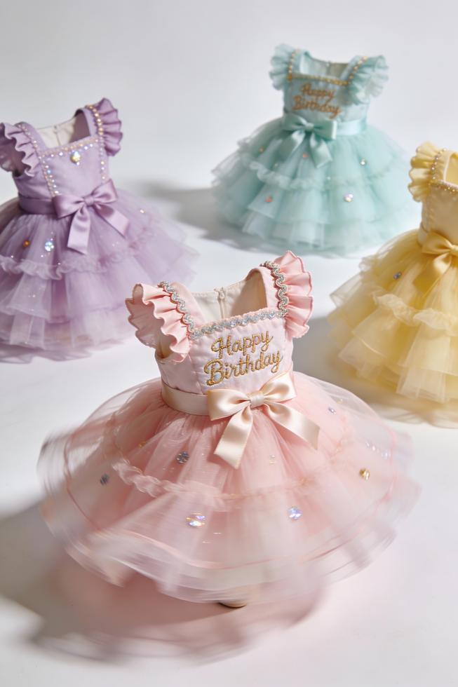 Cover image of pastel birthday tutu dresses arranged for display in a studio setting.