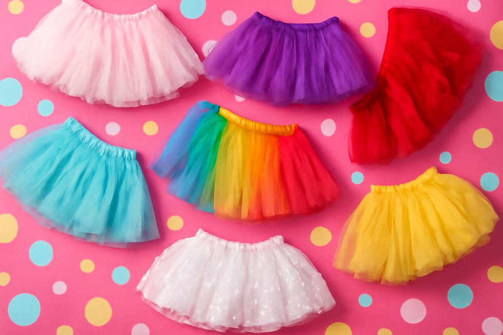 Colorful collection of girls' tutus in a playful setting.