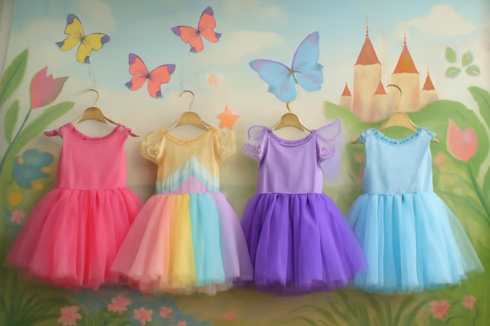 A colorful collection of children's tutu dresses displayed in a whimsical setting, emphasizing their playful designs and themes.
