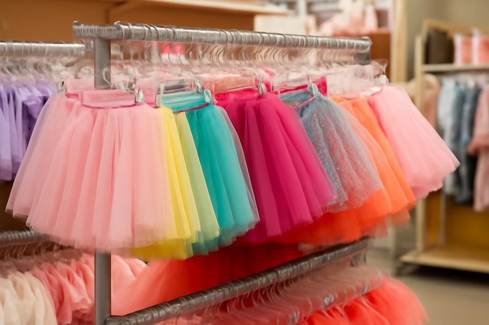 A lively scene of a retail display featuring a variety of toddler tutus, highlighting their charm and decorative features.